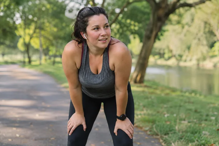 Illustration of a woman taking a break from exercise on a leafy park path